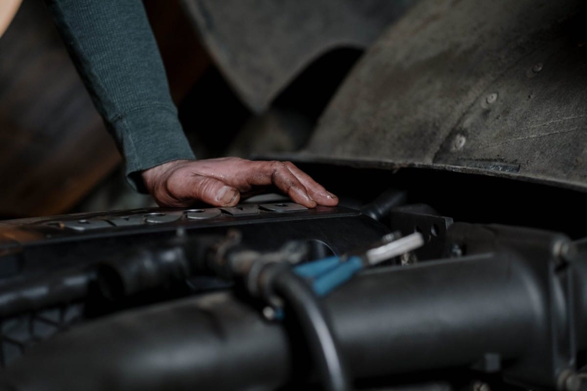 A car mechanic is working on the engine of a car.