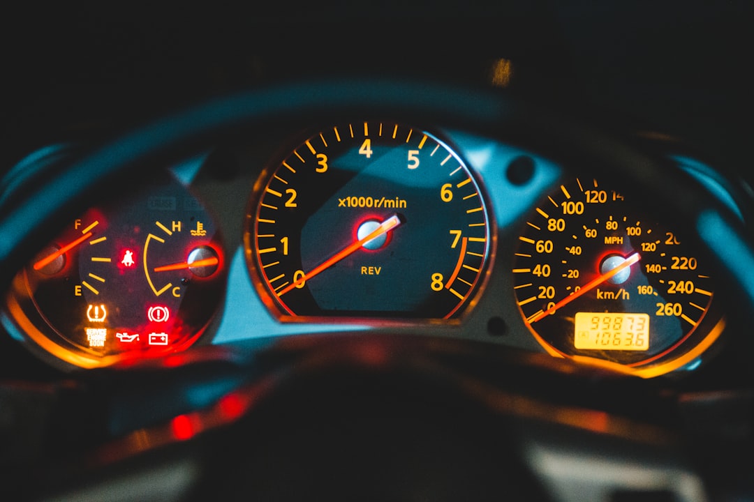 Close-up view of a car dashboard showing illuminated warning lights, including the check engine light immediate stop alert, speedometer, tachometer, fuel gauge, and odometer displaying 106,365 km.